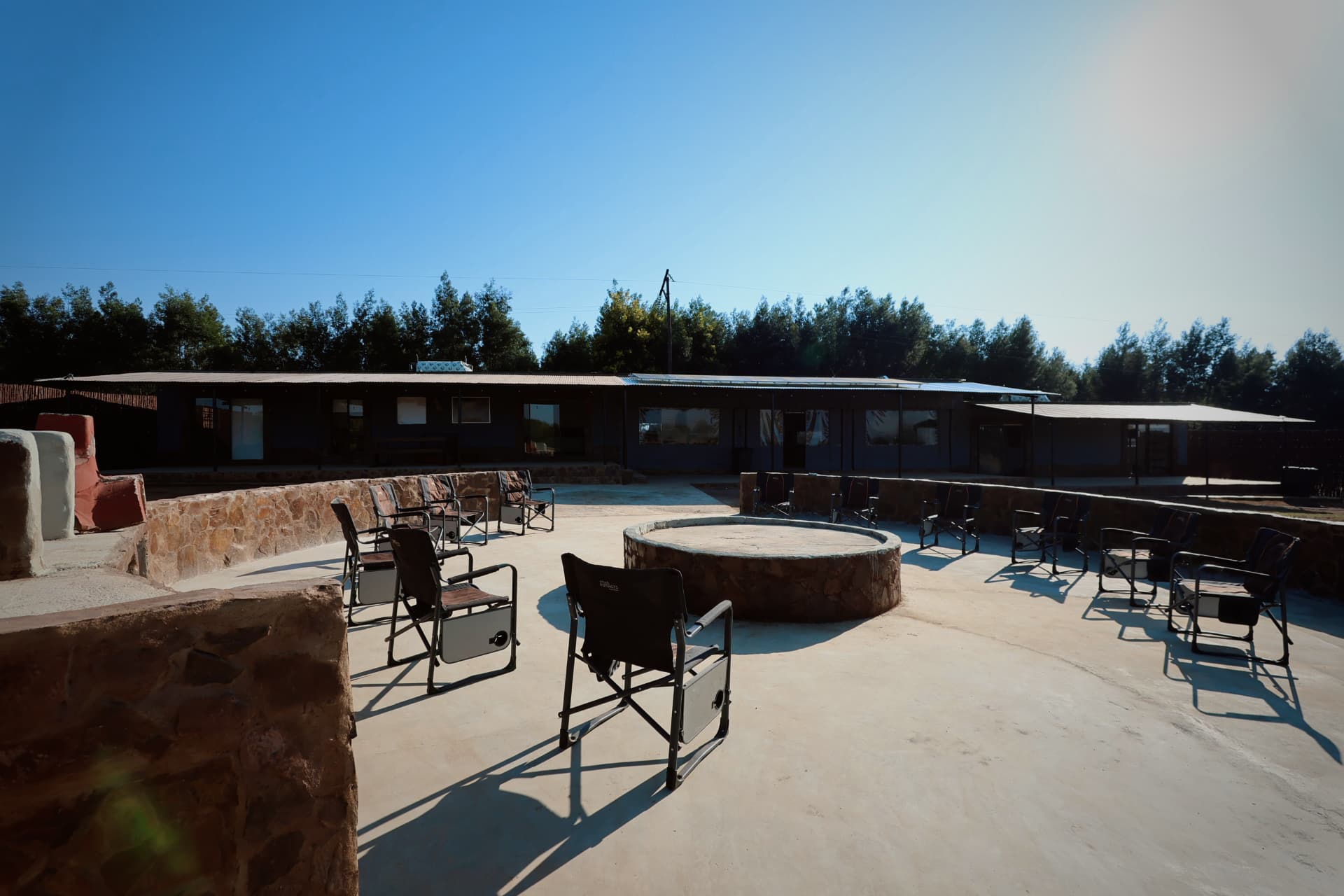 Stone fire pit and seating in front of the chalets
