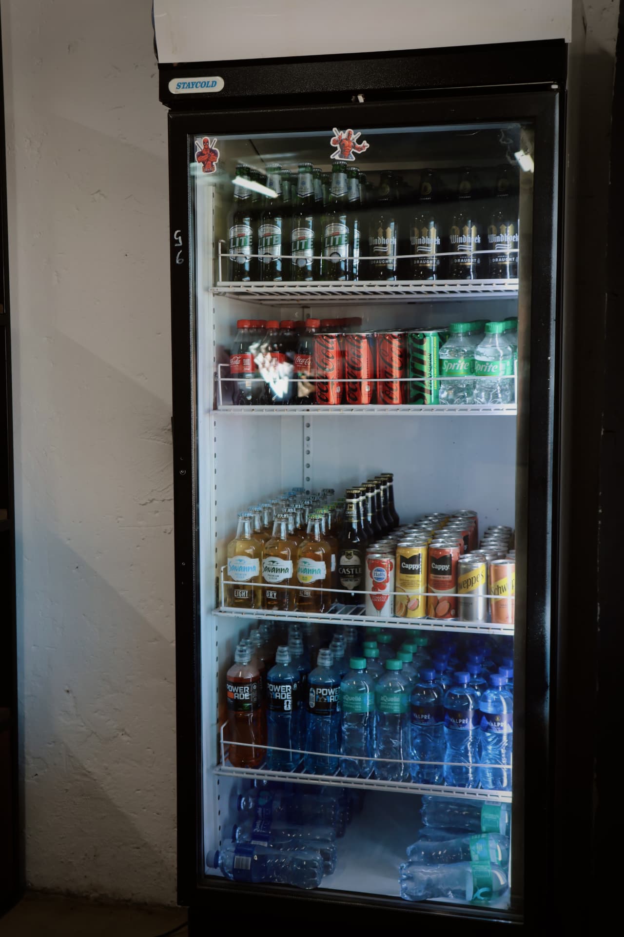 Stocked honesty bar fridge with cold drinks