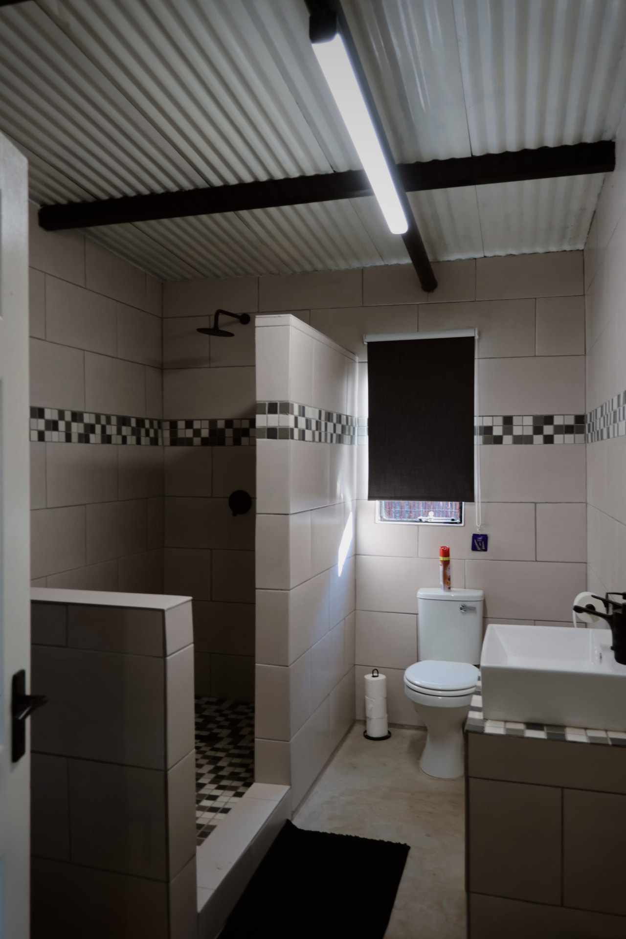 En suite bathroom with walk in shower and basin