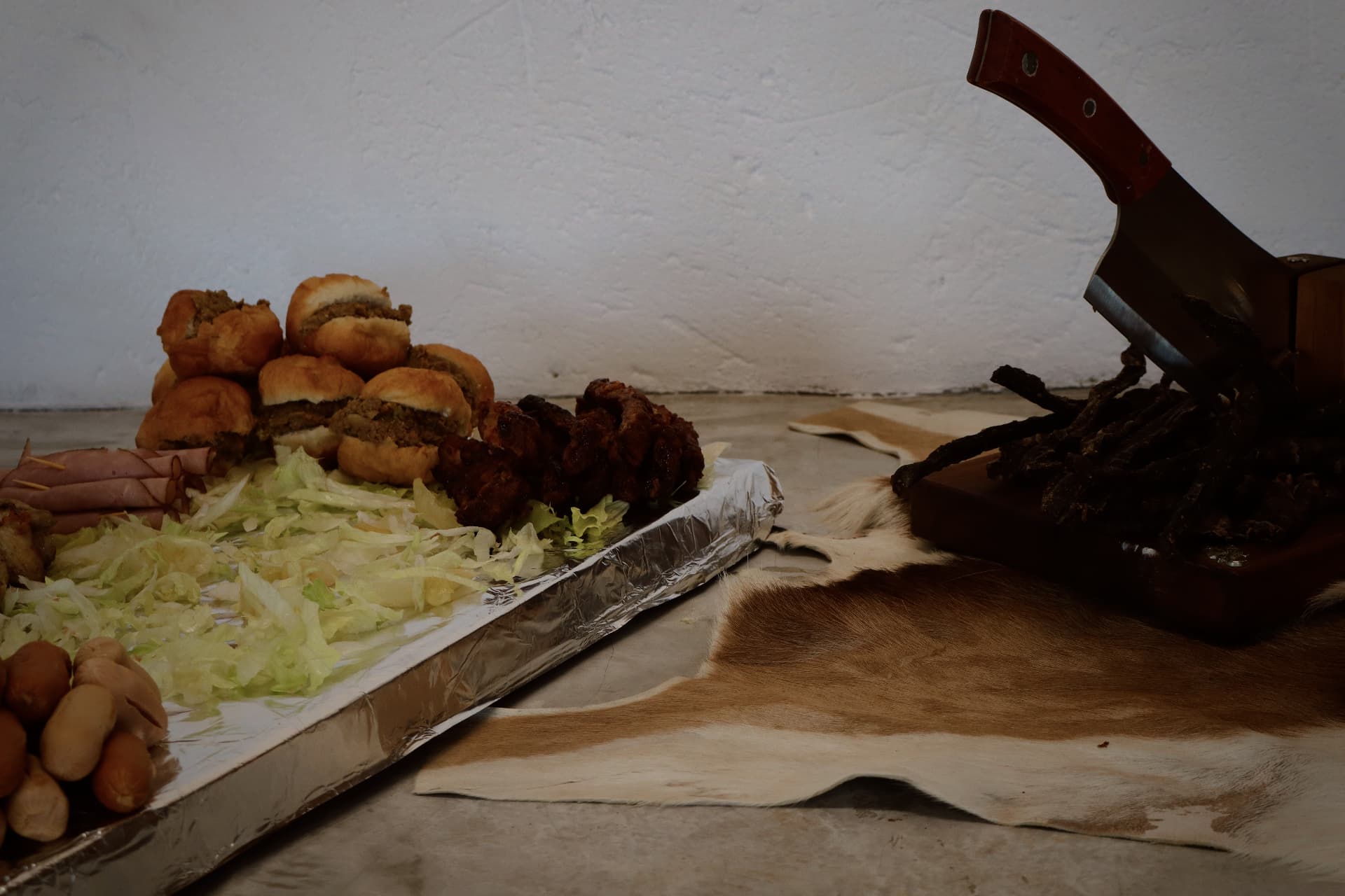 Snack platter with rolls, kebabs and biltong