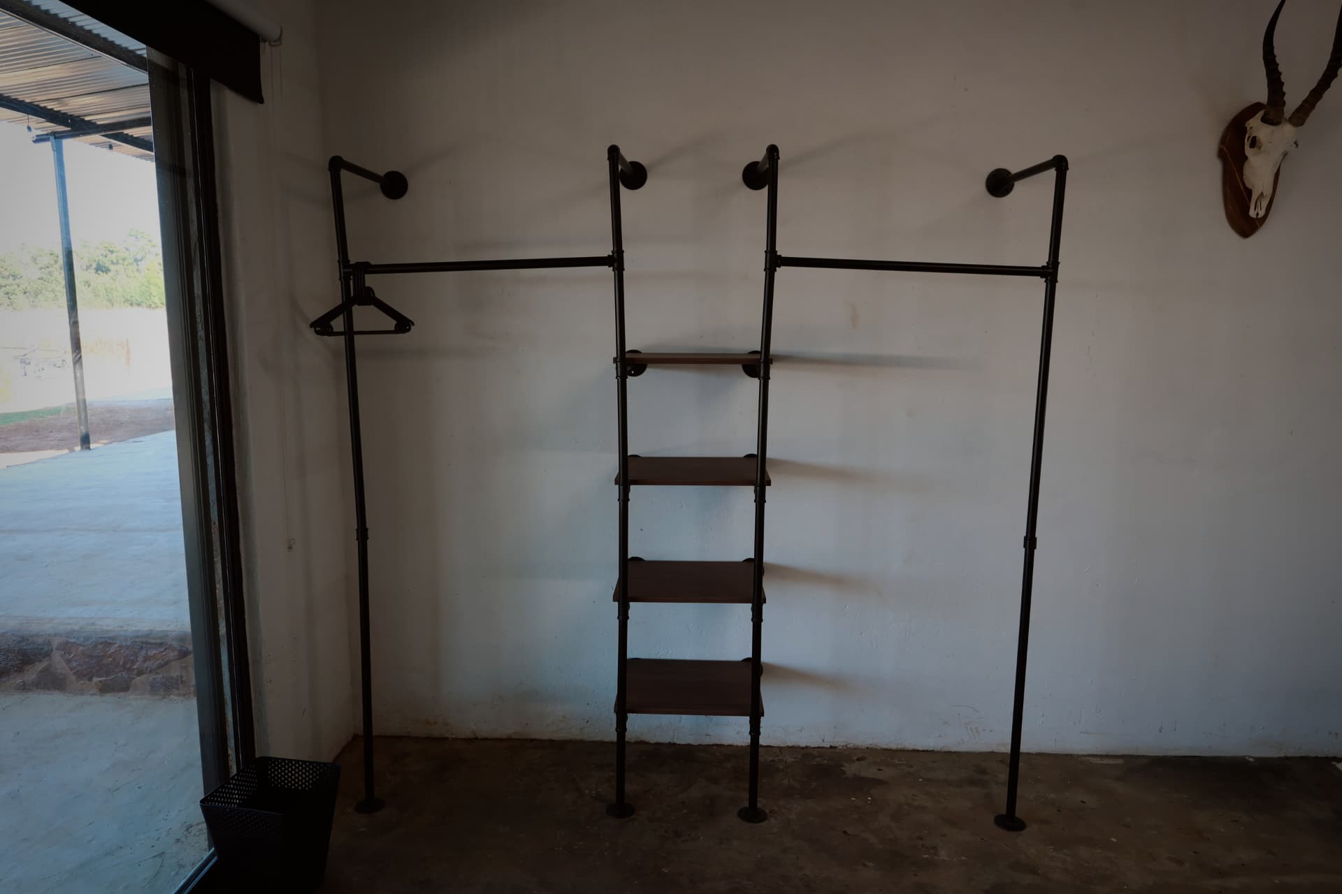 Open hanging rail and shelving in the guest room