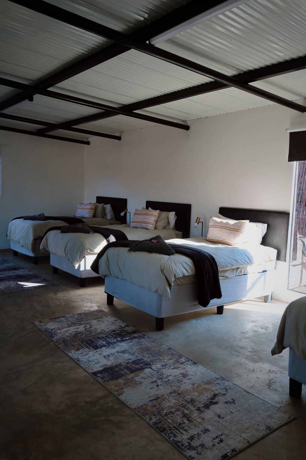 Four sleeper room with single beds and rugs