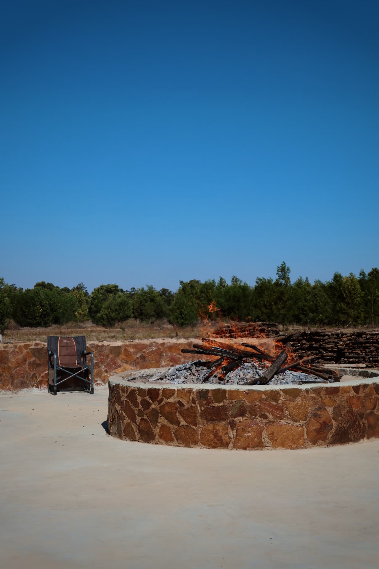 Stone fire pit burning at the boma