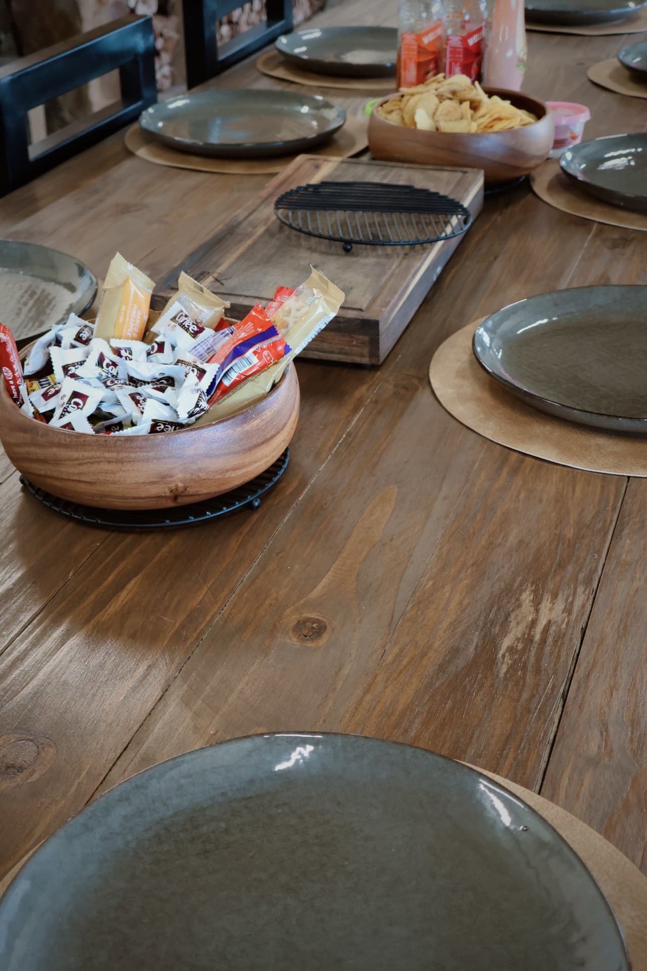 Dining table laid with snacks, plates and coffee