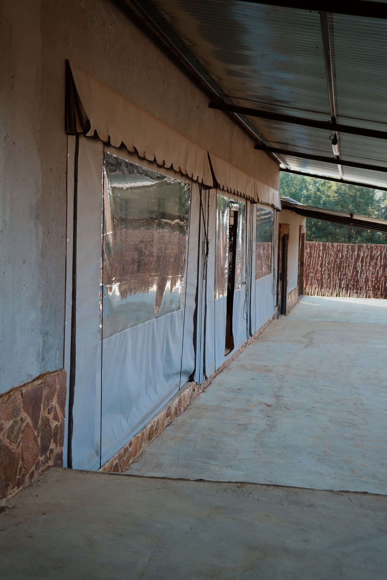 Covered veranda with roll down canvas blinds