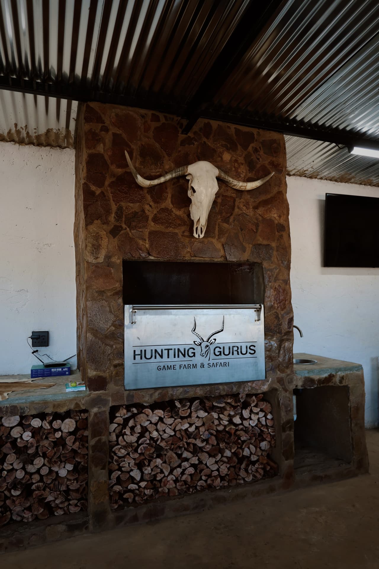 Indoor braai and stone fireplace in the lapa