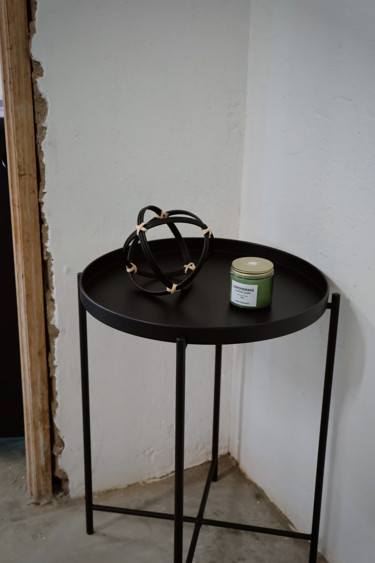 Lemongrass candle on a black tray table
