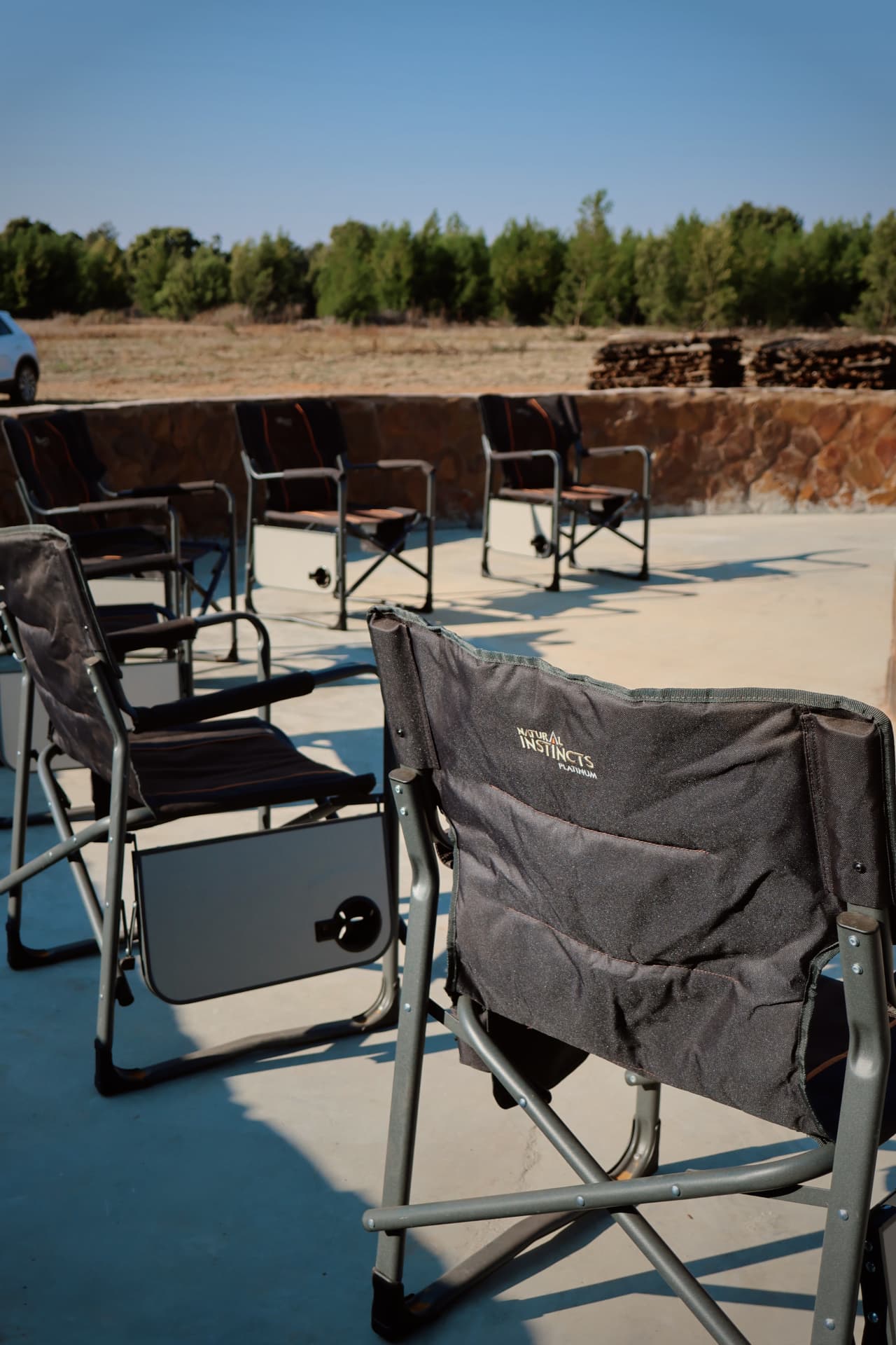 Camp chairs set out around the fire circle